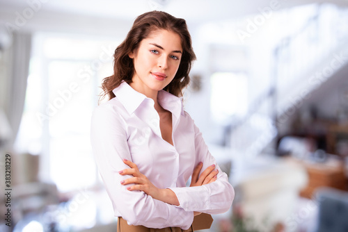 Young businesswoman portrait while standing in the offie.