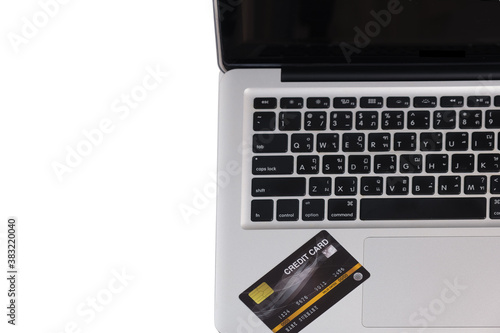 Close-up laptop and credit card top view free from copy space;  shopping/paying online using concept.
