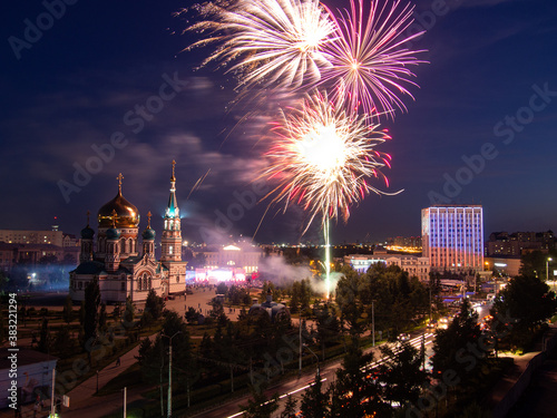 Fireworks over the Assumption Cathedral in Omsk. Festive fireworks in Omsk near the Assumption Cathedral and the government of the Omsk region.