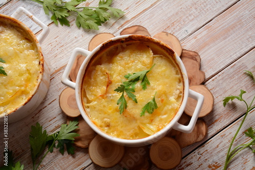 Potato gratin in baking white cocotte