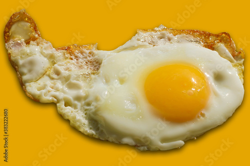 Single fried egg isolated on yellow background.