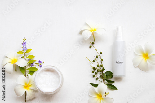 medication vanishing cream health care acne for skin face  collagen water spray with white flowers frangipani arrangement flat lay style on background white 