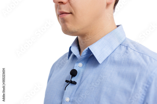 sound recording concept - close up of small lavalier microphone on male shirt photo