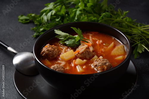 Patatesli Sulu Kofte - Turkish soup with meatballs in white bowl.