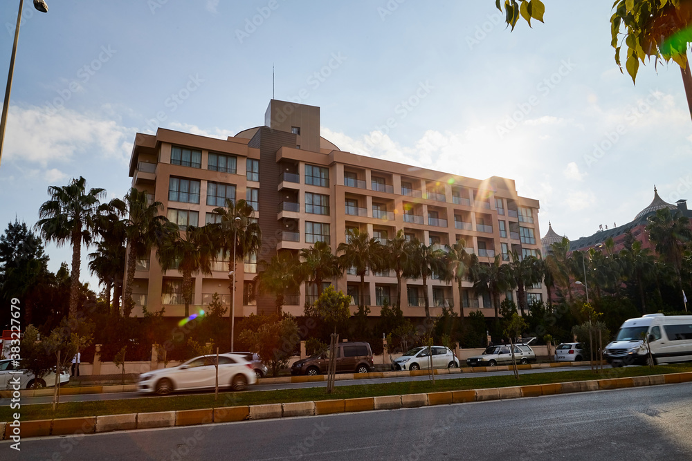 Naklejka premium Antalya, Turkey - December 21, 2019: Building of hotel in sunny day on the street of Lara in Antalya. The concept of rich and comfortable holiday in Turkey.