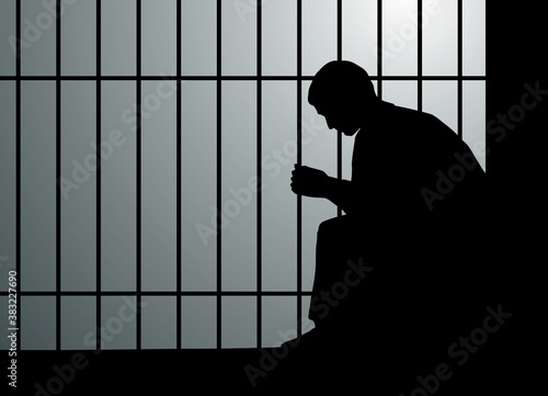 A man sits on a bench in prison. Vector drawing