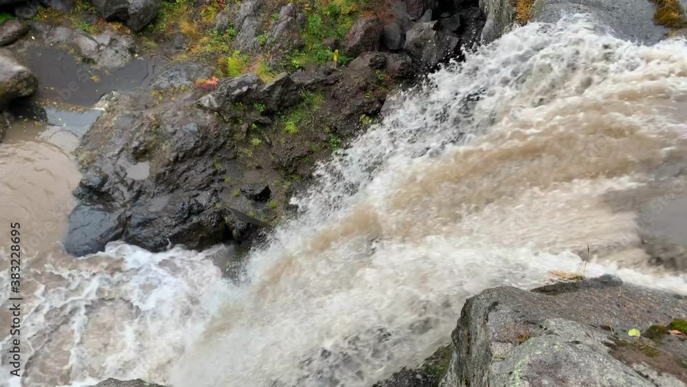 Powerful streams of the waterfall crash down to the ground. Beautiful place. Travel to the Kamchatka Peninsula. Amazing autumn landscape. Powerful streams of the waterfall crash down to the ground. Beautiful place. Travel to the Kamchatka Peninsula. Amazing autumn landscape.