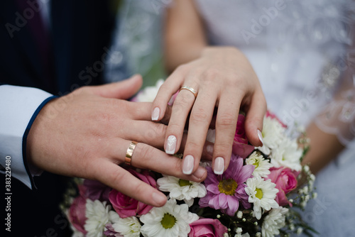 hands of bride and groom, bride and groom, hands with wedding rings, bouquet with bride