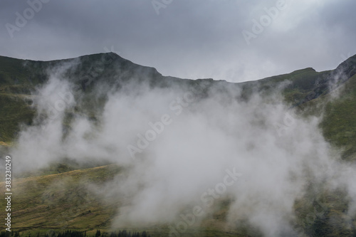 Fototapeta Naklejka Na Ścianę i Meble -  dense white raincloud while hiking in the mountains