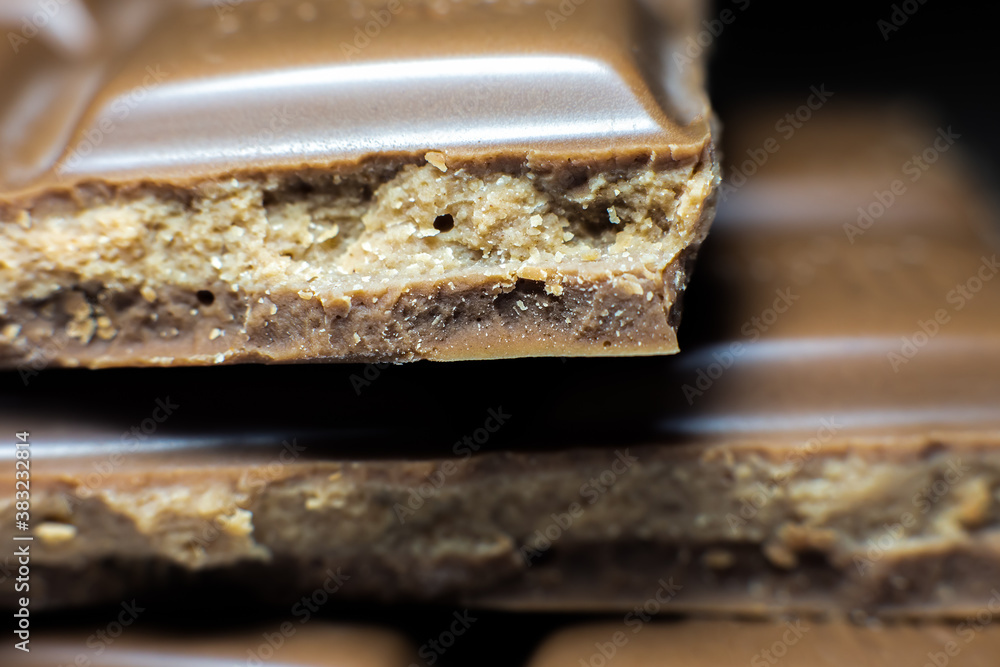 Milk chocolate bar lying on the table. Close up photo. Milk chocolate bar lying on the table. Close up photo.