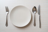 empty plate or dish with knife, fork and spoon