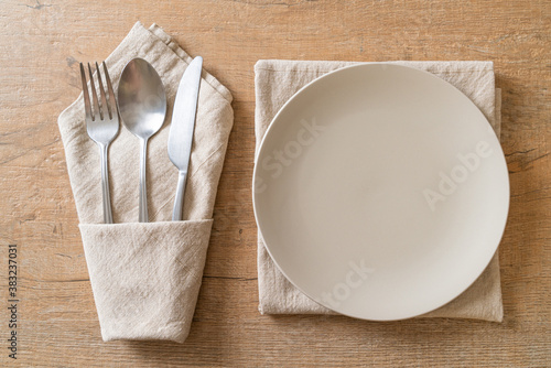empty plate or dish with knife, fork and spoon