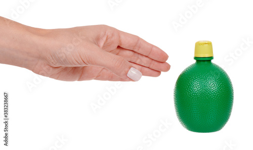 Quadro em tela Hand with concentrate lemon juice in a green bottle