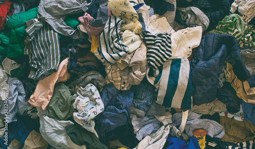 The background from the lots of kids clothes lying on the floor
