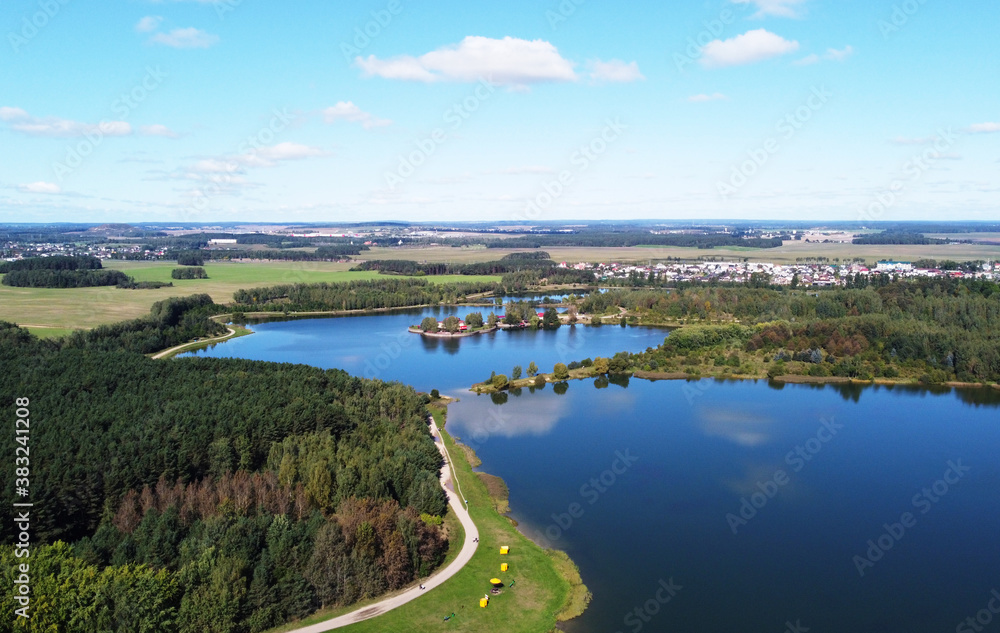 Top view of a beautiful city summer park with a lake and an embankment. Top view of a beautiful city summer park with a lake and an embankment.