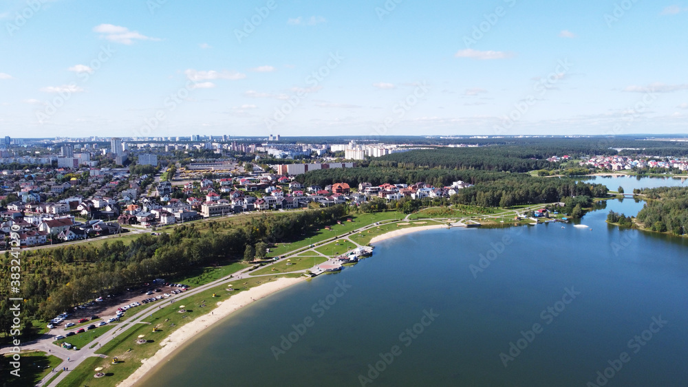 Fototapeta premium Top view of a beautiful city summer park with a lake and an embankment. 