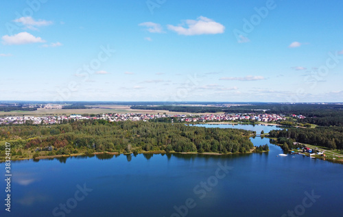 Top view of a beautiful city summer park with a lake and an embankment.  © Payllik
