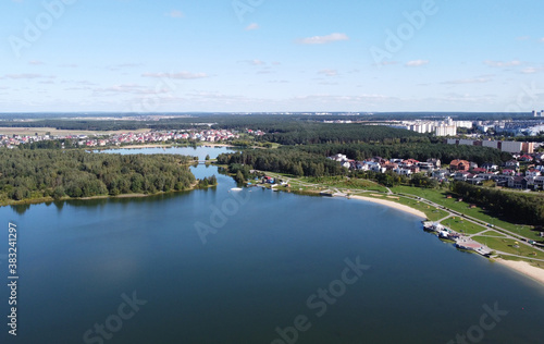 Top view of a beautiful city summer park with a lake and an embankment. 