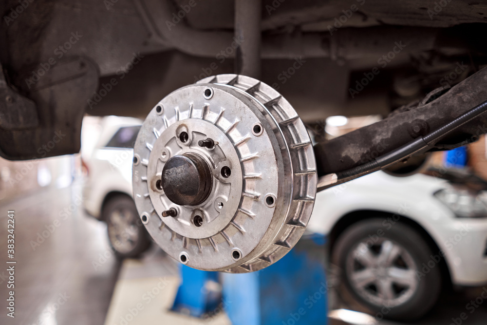 Rusty drum brakes, rear on car. Change the old to new brake disc on car in a garage. Auto mechanic repairing
