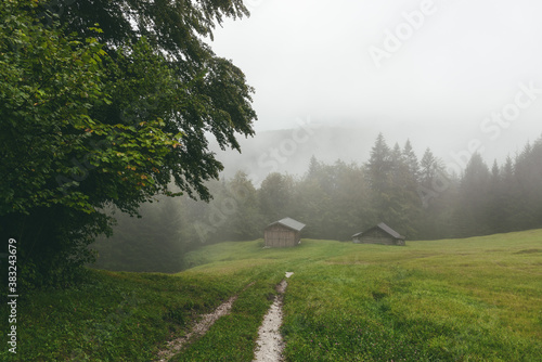 Almhütten bei Regen und Nebel photo