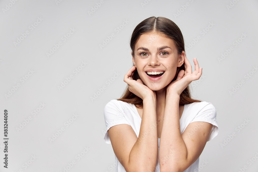 Cheerful woman smile white t-shirt straightens her hair Cheerful woman smile white t-shirt straightens her hair