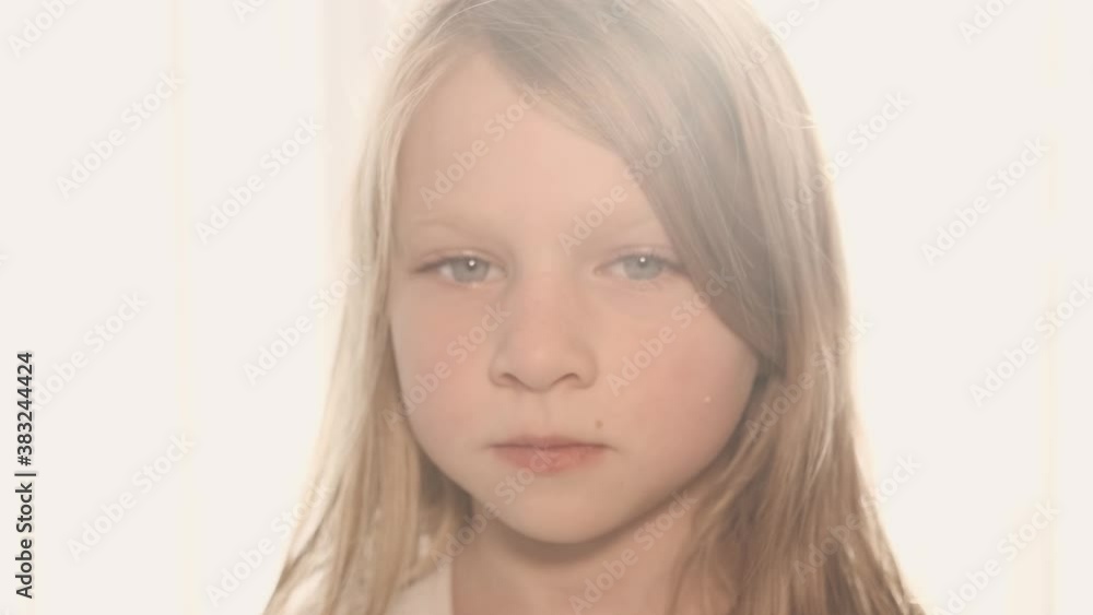 backlight and close up portrait of a serious caucasian girl looking in camera backlight and close up portrait of a serious caucasian girl looking in camera
