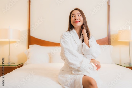 Portrait beautiful young asian woman smile relax on bed in bedroom interior © siraphol