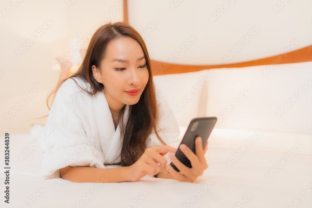 Portrait beautiful young asian woman use smart mobile phone on bed Portrait beautiful young asian woman use smart mobile phone on bed