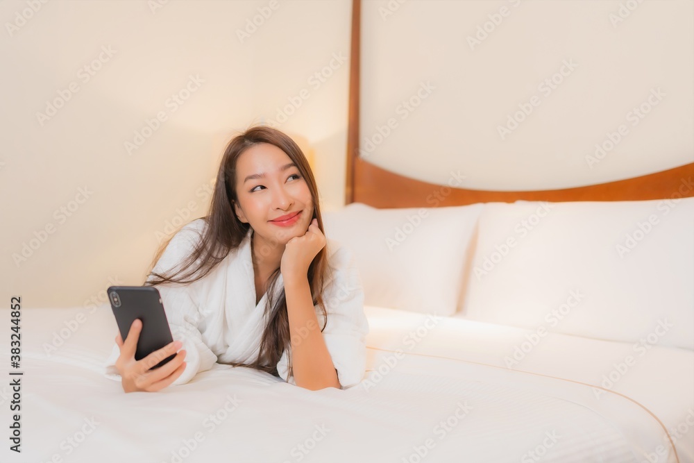 Portrait beautiful young asian woman use smart mobile phone on bed Portrait beautiful young asian woman use smart mobile phone on bed