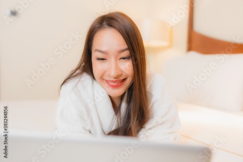 Portrait beautiful young asian woman use laptop on bed