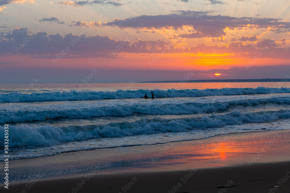 Fototapeta premium Image of summer sunny ocean waves and sunset in colorful tones
