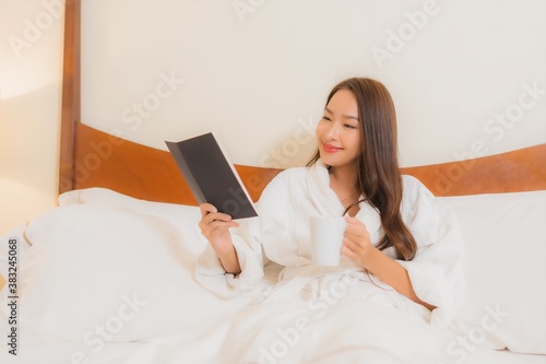 Portrait beautiful young asian woman read book on bed