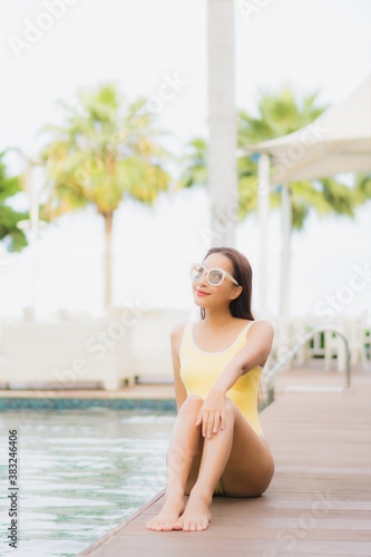 Portrait beautiful young asian woman relax smile leisure around outdoor swimming pool