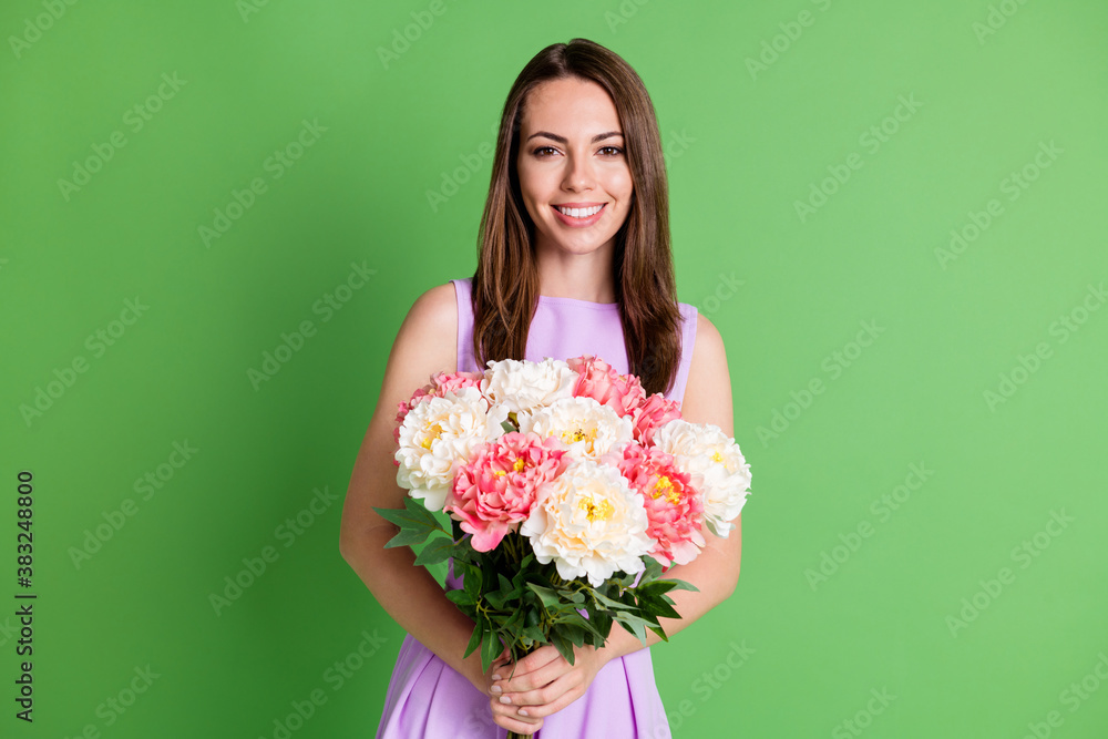 Portrait of her she nice attractive pretty lovely cheerful cheery girl enjoying holiday St Saint Patrick day holding in hands floral bunch isolated over green color background Portrait of her she nice attractive pretty lovely cheerful cheery girl enjoying holiday St Saint Patrick day holding in hands floral bunch isolated over green color background