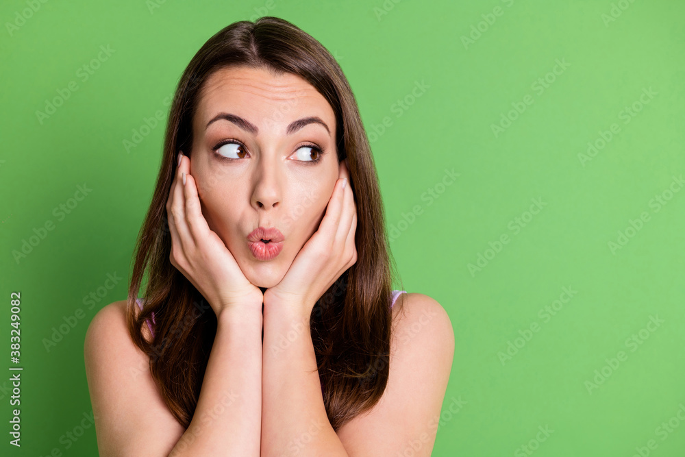 Photo of nice lovely young lady woman look empty space astonished information hands cheeks see new shopping products brown hair cover clothes isolated green pastel color background Photo of nice lovely young lady woman look empty space astonished information hands cheeks see new shopping products brown hair cover clothes isolated green pastel color background