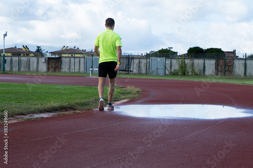 A man walking on the running track. © Patricio