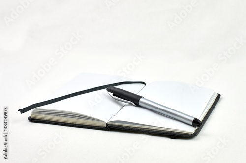 notebook with pen on white background
