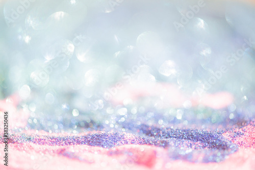 Abstract bright glitter lights colorful bokeh background in pastel blue pink and purple color