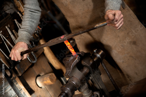 Close-up of blacksmith hands holding working tools