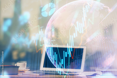 Financial chart drawing and table with computer on background. Double exposure. Concept of international markets.