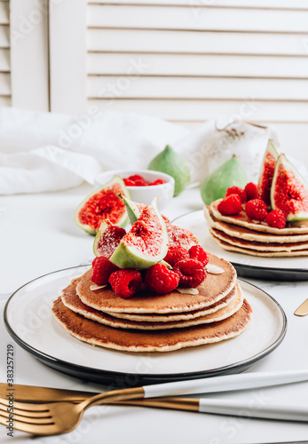Homemade classic american pancakes with almond  fresh raspberries and figs