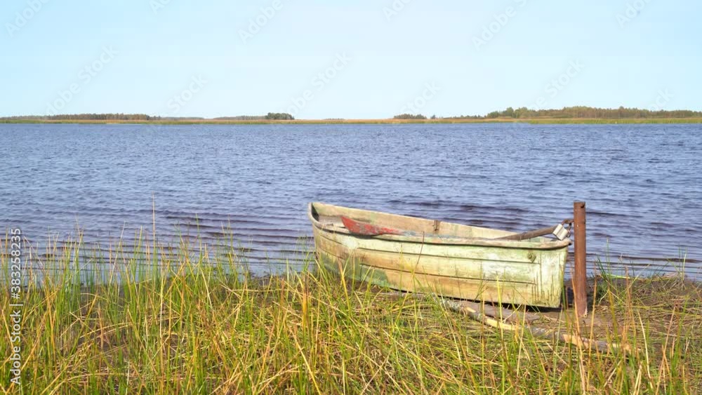 Svyatoe lake in the Meshchersky region in Russia with A broken boat in the foreground. Svyatoe lake in the Meshchersky region in Russia with A broken boat in the foreground.