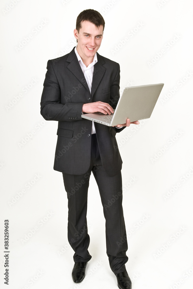 Young man in business suit with laptop Young man in business suit with laptop