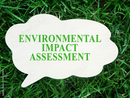 White plate with words Environmental impact assessment EIA. photo