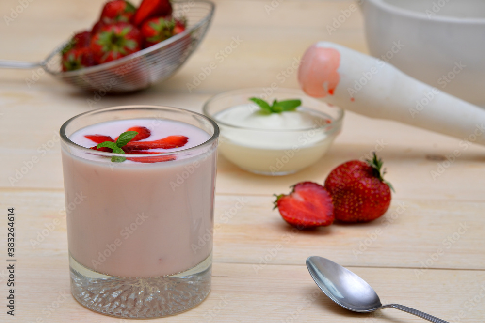 yogurt with strawberries a glass of strawberry yogurt and ingredients for making it berries and dairy products yogurt with strawberries a glass of strawberry yogurt and ingredients for making it berries and dairy products