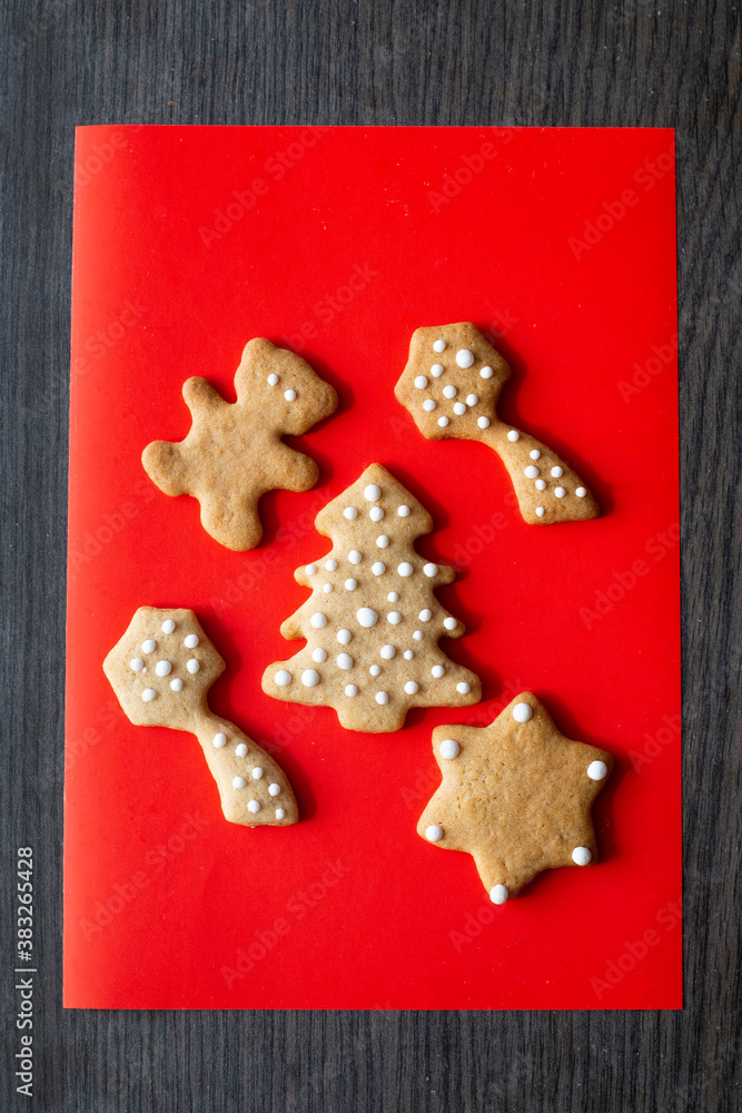 festive layout of New Year's  gingrerbread cookies on a red background. Merry Christmas and Happy New Year card