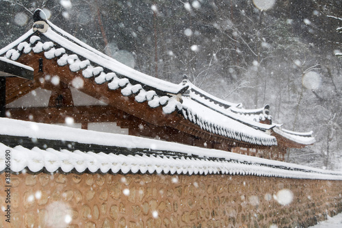 Korean temple roof covered in snow
