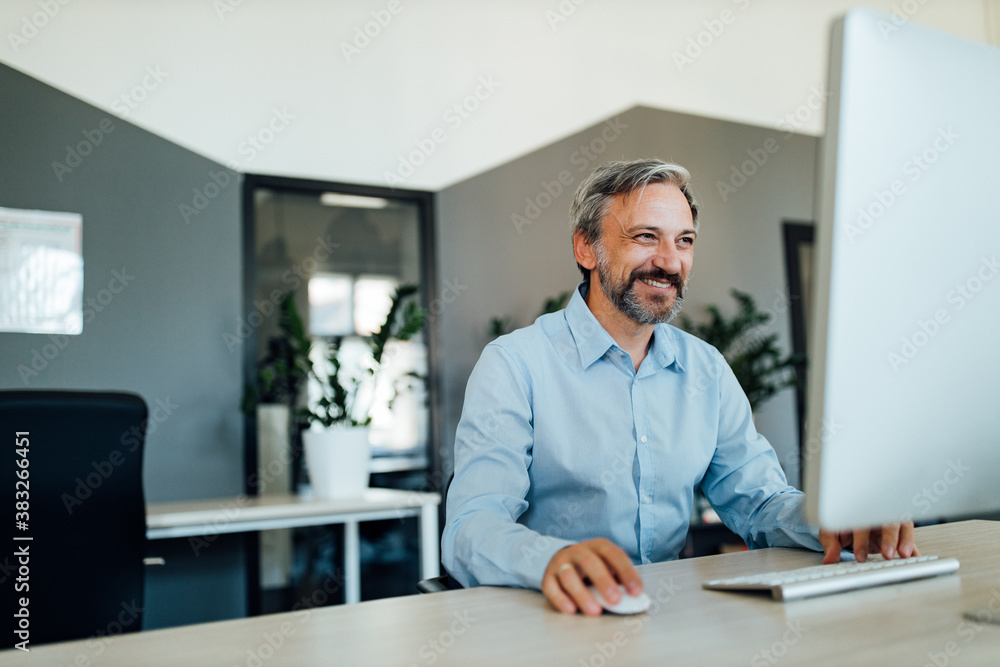 Happy man using his computer. Happy man using his computer.