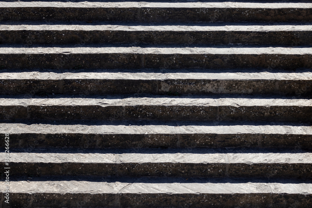 Medieval stone stairs in sunny day background texture