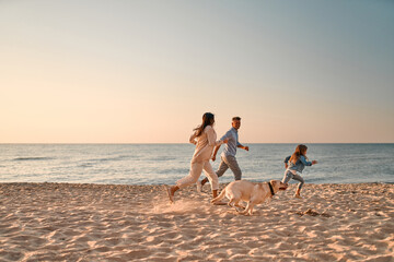 Family with dog on the beach